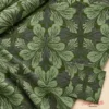 Olive green floral seamless pattern shown on fabric and textile swatch